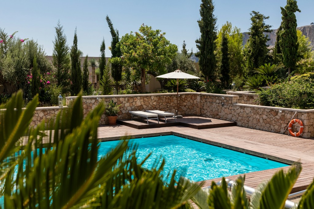 Luxury swimming pool with wooden deck and clear blue water